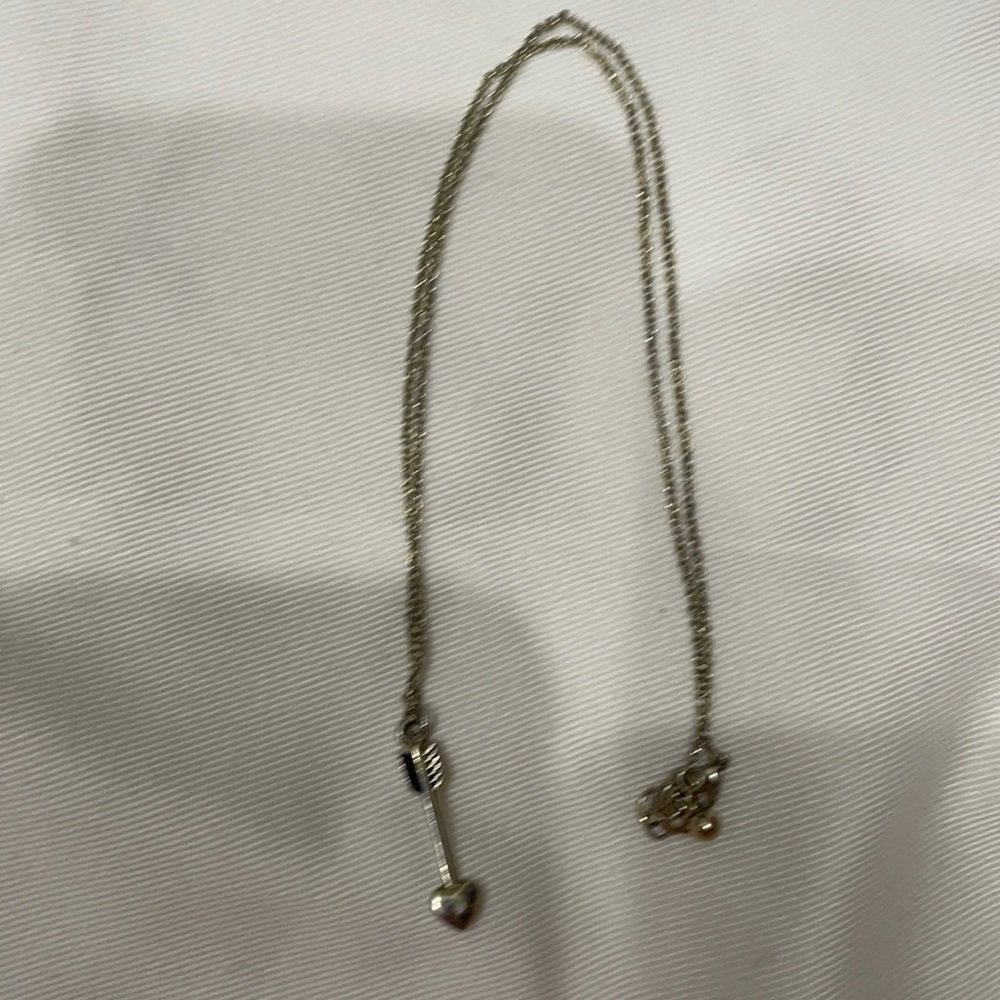 Gold arrow necklace.